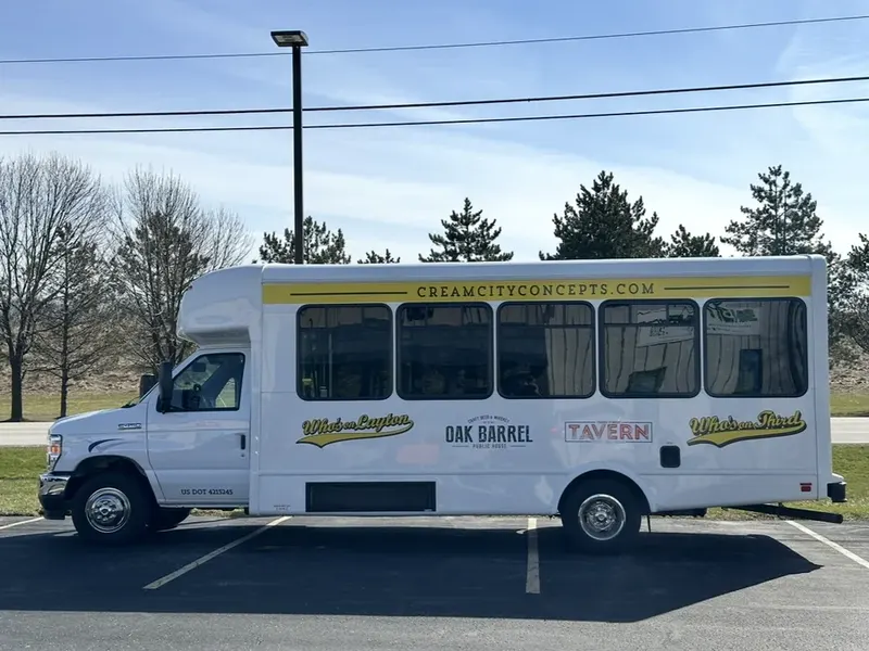 Side profile of the shuttle bus showing the full length of the vehicle